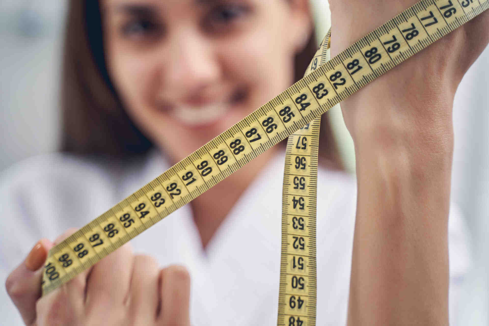 women in Texas proudly showing inches loss from using weight loss medication